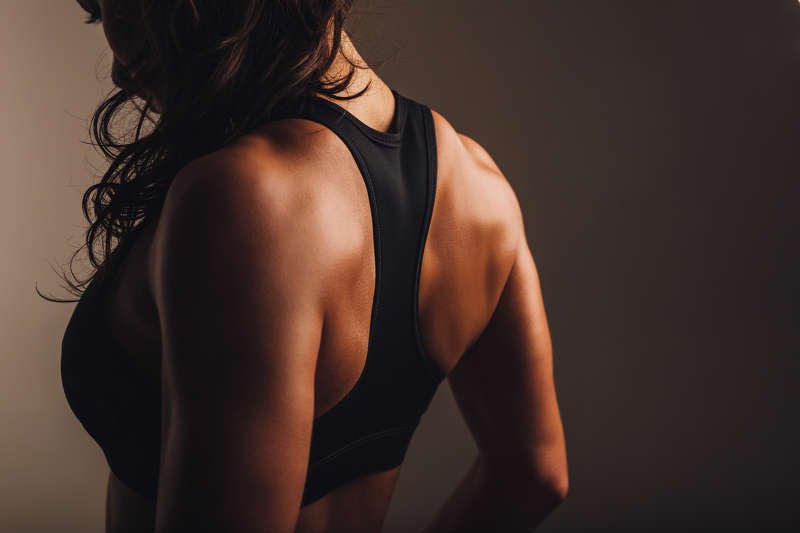 Muscular young woman wearing bra and jeans – Jacob Lund Photography Store-  premium stock photo