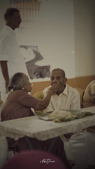 Elderly Woman Feeding Her Husband