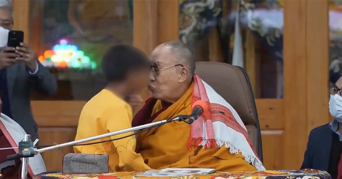 Tibetan leader Dalai Lama kisses a minor boy