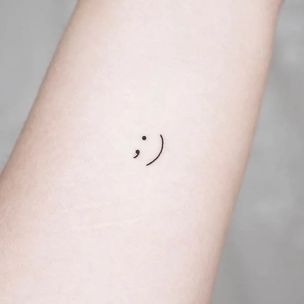 Semicolon tattoo on wrist