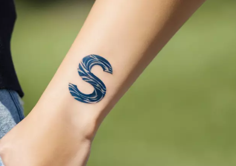 s letter tattoo on wrist