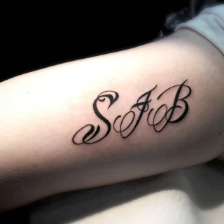 s letter tattoo on wrist