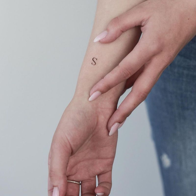 s letter tattoo on wrist