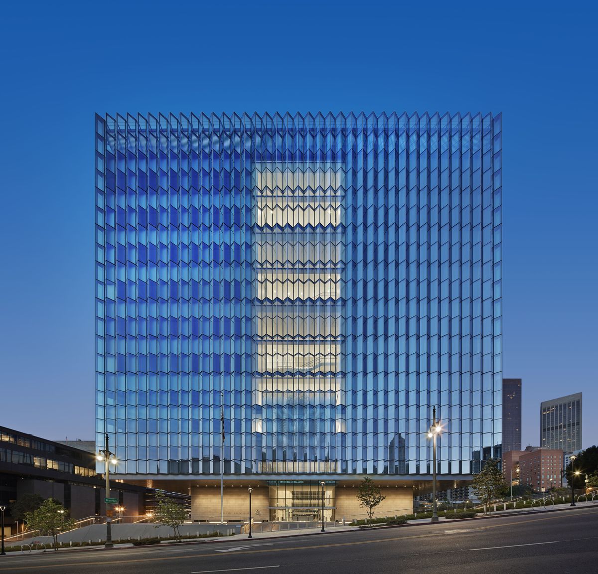 Modern glass-fronted courthouse exterior at dusk