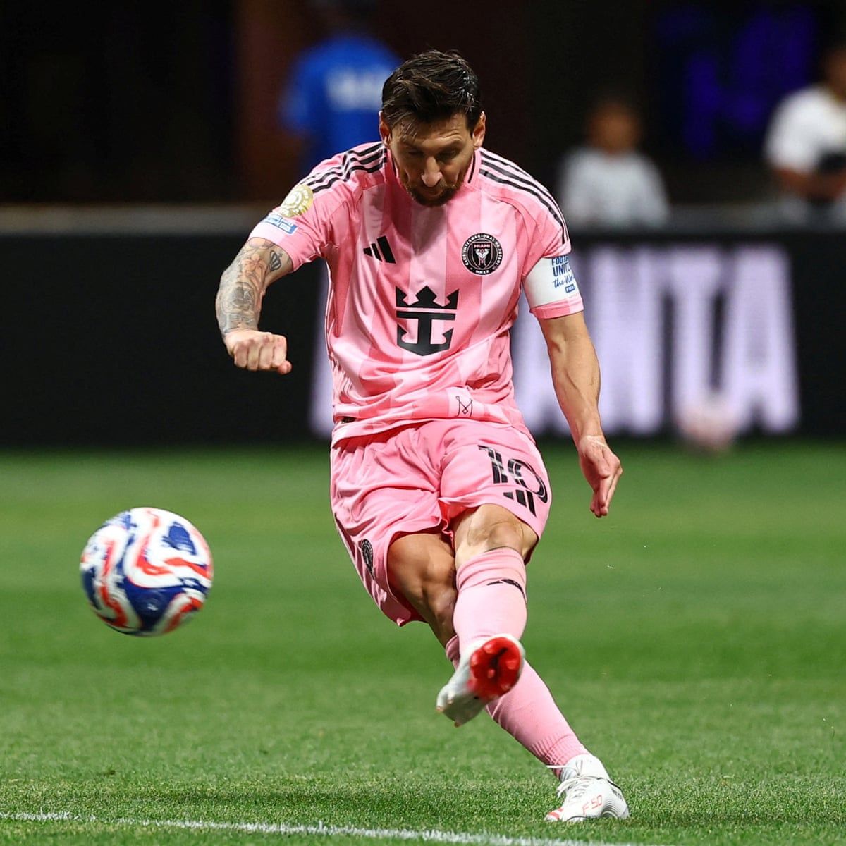 Messi shooting a football in Inter Miami's pink kit