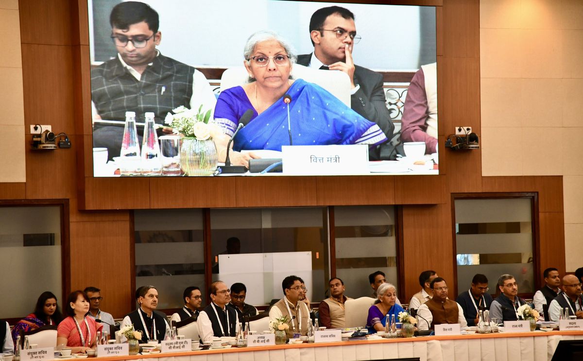 GST meeting in session, government officials and ministers discussing rate structure.