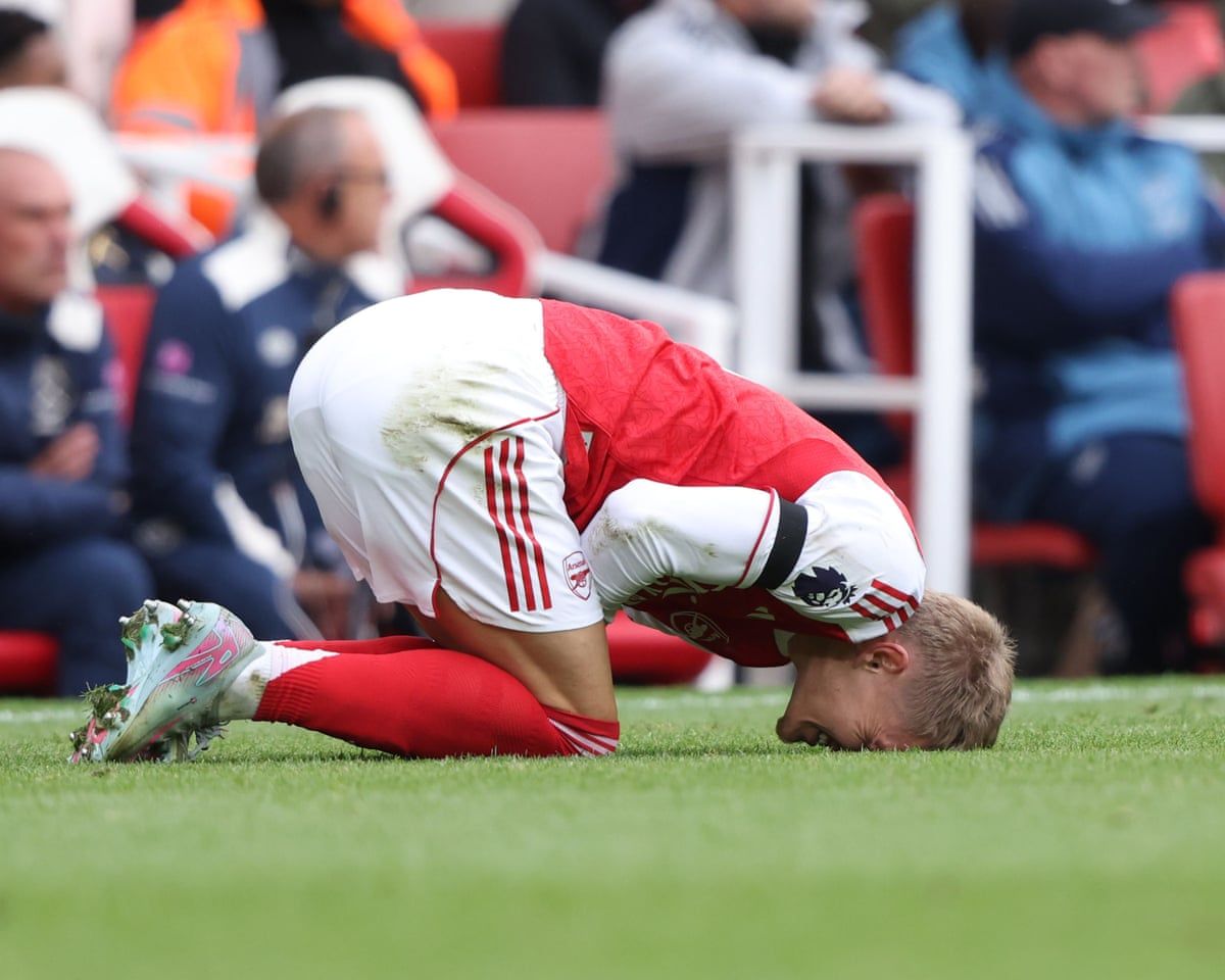 Arsenal player down injured on turf