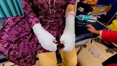 Victim with bandaged hands after acid attack